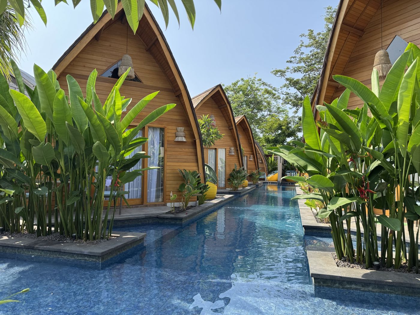 Wooden bungalows along a pool in Indonesia
