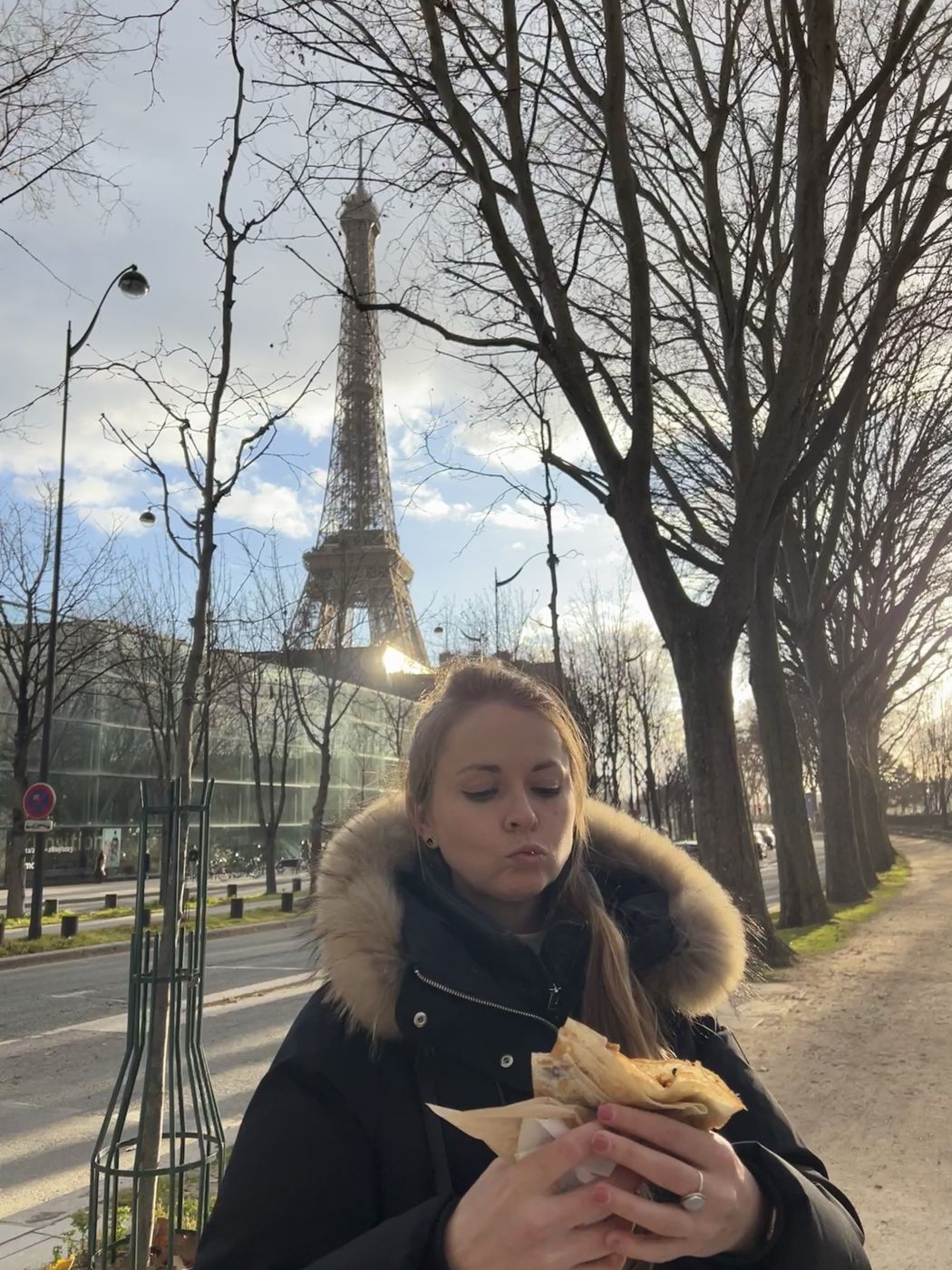 Berenice eating a crepe by the Eiffel Tower