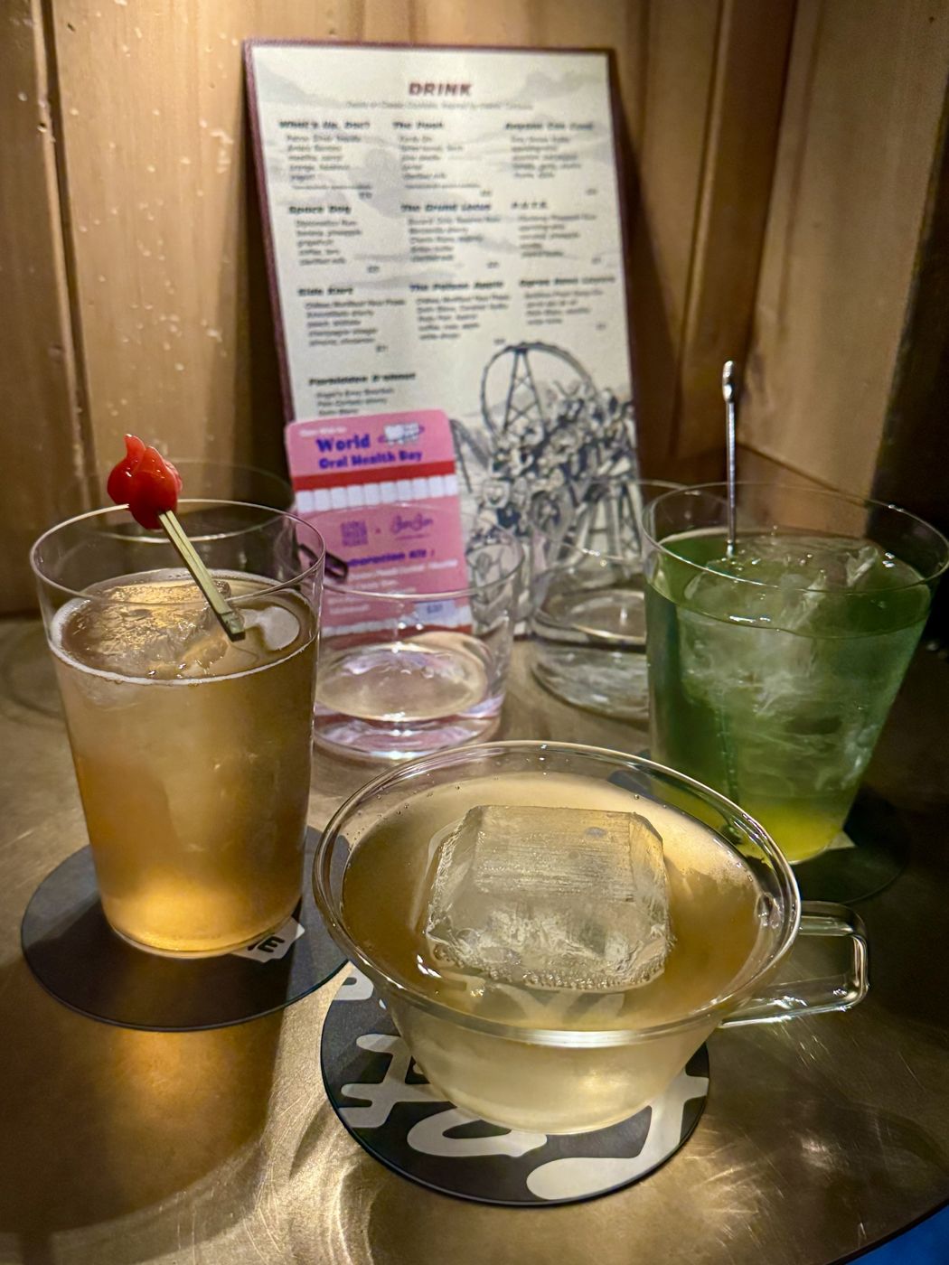 Three cocktails at a speakeasy bar
